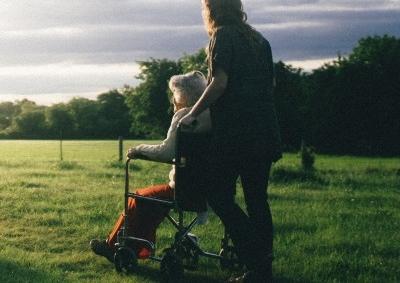 Elderly woman and carer out on a walk